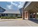 Beautifully landscaped building exterior with brick columns and a well-maintained garden at 18531 Bent Pine Dr, Hudson, FL 34667