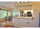 Bright eat-in kitchen with bar seating and views to the living room and outdoor landscape at 18531 Bent Pine Dr, Hudson, FL 34667