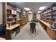 Community library with floor to ceiling bookshelves, tables, and chairs for reading or group gatherings at 18531 Bent Pine Dr, Hudson, FL 34667
