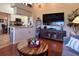 Open-concept living room with vaulted ceilings, a ceiling fan, and a comfortable blue sofa at 18531 Bent Pine Dr, Hudson, FL 34667