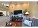 Open-concept living room with vaulted ceilings, a ceiling fan, and a comfortable blue sofa at 18531 Bent Pine Dr, Hudson, FL 34667