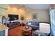 Cozy living room with vaulted ceilings, a ceiling fan, and a comfortable blue sofa at 18531 Bent Pine Dr, Hudson, FL 34667
