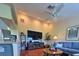 Open-concept living room with vaulted ceilings, a ceiling fan, and a comfortable blue sofa at 18531 Bent Pine Dr, Hudson, FL 34667