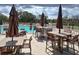 Relaxing pool area with comfortable patio seating and shaded umbrellas, ideal for outdoor enjoyment at 18531 Bent Pine Dr, Hudson, FL 34667