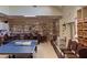 Spacious recreation room featuring tables, chairs, ping pong, and built-in shelving for storage and display at 18531 Bent Pine Dr, Hudson, FL 34667
