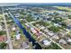 Aerial view of a waterfront neighborhood with canals and tropical landscaping at 18702 Van Nuys Cir, Port Charlotte, FL 33948