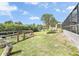Expansive backyard featuring landscaping and a chicken coop at 18702 Van Nuys Cir, Port Charlotte, FL 33948