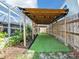 Backyard featuring a covered area, a fence, and landscaping at 18702 Van Nuys Cir, Port Charlotte, FL 33948
