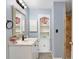 Inviting bathroom with modern fixtures, built in shelving, and a tiled shower at 18702 Van Nuys Cir, Port Charlotte, FL 33948