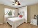 Cozy bedroom featuring a Murphy bed, ceiling fan, and a window with natural light at 18702 Van Nuys Cir, Port Charlotte, FL 33948