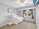 Cozy bedroom with soft carpet, a window view, and a comfortable daybed perfect for relaxation at 18702 Van Nuys Cir, Port Charlotte, FL 33948
