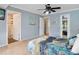 Comfortable bedroom featuring serene blue walls and access to other areas of the home at 18702 Van Nuys Cir, Port Charlotte, FL 33948