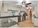 A well-equipped kitchen offers stainless steel appliances, light cabinetry, granite countertops, and hardwood floors at 18702 Van Nuys Cir, Port Charlotte, FL 33948