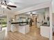 A well-equipped kitchen offers stainless steel appliances, light cabinetry, granite countertops, and hardwood floors at 18702 Van Nuys Cir, Port Charlotte, FL 33948