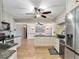 Bright kitchen with cream cabinets, granite countertops, stainless steel appliances, and a convenient island at 18702 Van Nuys Cir, Port Charlotte, FL 33948