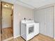 Laundry room with modern appliances, tile floors, and ample storage space with closet at 18702 Van Nuys Cir, Port Charlotte, FL 33948