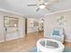 The sun-drenched living room boasts hardwood floors, neutral walls, and seamless access to the dining area at 18702 Van Nuys Cir, Port Charlotte, FL 33948