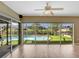 Living room with hardwood floors and screened sliding glass doors leading to the pool at 18702 Van Nuys Cir, Port Charlotte, FL 33948