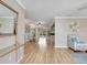 The sun-drenched living room boasts hardwood floors, neutral walls, and seamless access to the dining area at 18702 Van Nuys Cir, Port Charlotte, FL 33948