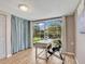 Home office with wood floors, a modern desk, and sliding glass doors to the screened lanai at 18702 Van Nuys Cir, Port Charlotte, FL 33948