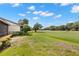 Landscaped backyard offers views of the lush golf course and mature trees at 190 Dale Pl, Oldsmar, FL 34677