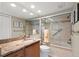 Bright bathroom with granite countertop, lots of light and large mirror and shower featuring safety bars at 190 Dale Pl, Oldsmar, FL 34677