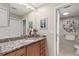 Updated bathroom with granite countertops, wood cabinets, and decorative art, offering a stylish and functional space at 190 Dale Pl, Oldsmar, FL 34677
