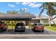 Exterior view with covered parking area, palm trees, and landscaped front yard at 190 Dale Pl, Oldsmar, FL 34677