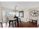 Cozy dining area with dark wood table, contemporary chairs, and view to the outside at 190 Dale Pl, Oldsmar, FL 34677