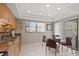 Cozy eat-in kitchen area with glass table, four chairs, and a sliding door to the outside at 190 Dale Pl, Oldsmar, FL 34677