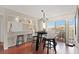 Bright dining area features hardwood floors and modern chandelier above a round table and chairs at 190 Dale Pl, Oldsmar, FL 34677