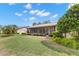A shot of the back of the home that shows the screened in porch and back yard at 190 Dale Pl, Oldsmar, FL 34677