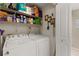 Convenient laundry room featuring washer, dryer, and shelving for ample storage of supplies at 190 Dale Pl, Oldsmar, FL 34677