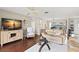 Bright living room featuring a media console, comfortable sofa, and a view into the dining area at 190 Dale Pl, Oldsmar, FL 34677