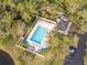 Aerial image of a community pool with surrounding trees and ample parking at 190 Dale Pl, Oldsmar, FL 34677