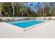 Community pool with ample seating and lush trees at 190 Dale Pl, Oldsmar, FL 34677