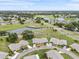 Aerial view of a home highlighting its location within a vibrant community with ponds and green spaces at 2214 Highclere Cir # 6, Sun City Center, FL 33573