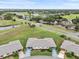 Aerial view of home, showcasing mature landscaping and a golf course with ponds in a desirable neighborhood at 2214 Highclere Cir # 6, Sun City Center, FL 33573