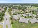 Wide aerial perspective of a residential community, showcasing the layout, landscaping, and surrounding area at 2214 Highclere Cir # 6, Sun City Center, FL 33573