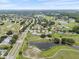 Scenic aerial view of a community near a road, featuring lakes, lush foliage, and well-maintained homes at 2214 Highclere Cir # 6, Sun City Center, FL 33573