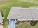 An aerial shot of a well-maintained home with fresh landscaping, mature shrubs, and a fresh driveway and walkway at 2214 Highclere Cir # 6, Sun City Center, FL 33573