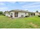 Well-maintained backyard with lush lawn, mature landscaping, and partial shade at 2214 Highclere Cir # 6, Sun City Center, FL 33573