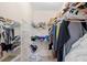 Walk-in closet providing ample storage space with clothing racks and shelving at 2214 Highclere Cir # 6, Sun City Center, FL 33573
