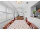Bright dining room showcasing views into living room, ample natural light from many windows at 2214 Highclere Cir # 6, Sun City Center, FL 33573