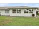 Charming single-story home featuring a white exterior, well-maintained lawn and bright windows with green trim accents at 2214 Highclere Cir # 6, Sun City Center, FL 33573