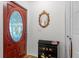 Foyer featuring a stained-glass door, mirror, cabinet, and closet space at 2214 Highclere Cir # 6, Sun City Center, FL 33573