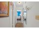 Hallway leads to a bright bedroom with new flooring and closet space at 2214 Highclere Cir # 6, Sun City Center, FL 33573