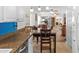 Open kitchen with granite countertops that flow into dining and living spaces at 2214 Highclere Cir # 6, Sun City Center, FL 33573