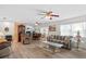 Spacious living room featuring hardwood floors, an open floor plan, and a cozy sitting area at 2214 Highclere Cir # 6, Sun City Center, FL 33573