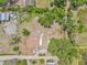 Expansive aerial view of property featuring home, large treed lot, detached garage, and spacious outdoor area at 2233 Rightaway Ln, Plant City, FL 33565